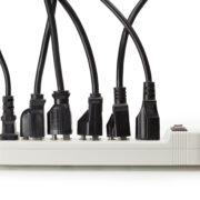 multiple plug load power cords plugged into power strip