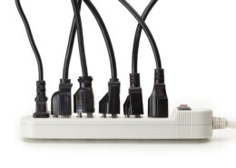 multiple plug load power cords plugged into power strip
