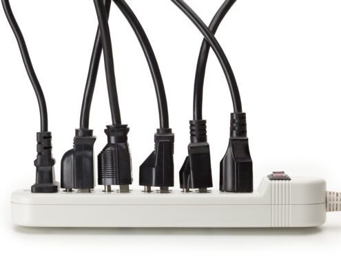 multiple plug load power cords plugged into power strip