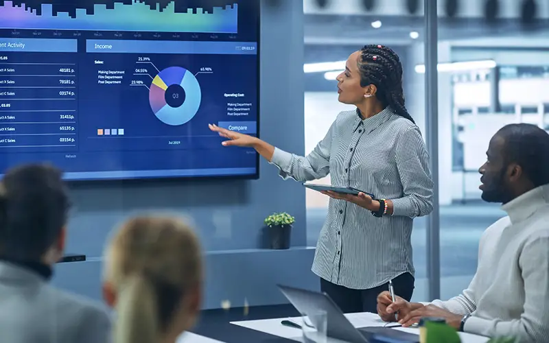 African American woman giving a presentation with a smartboard.